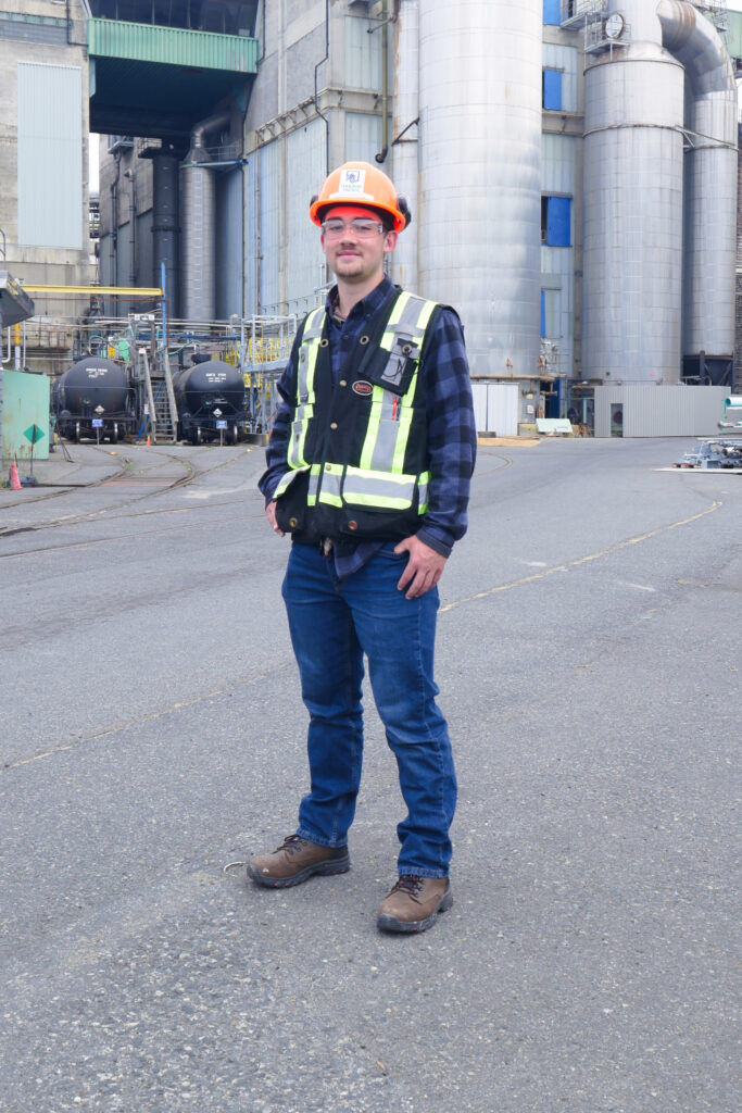 Person in front of industrial buildings